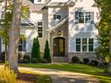 View of front door with stone archway and covered porch, framed by manicured landscaping at 8709 Kimalden Ct, Wake Forest, NC 27587