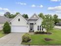 Attractive single-story home features a lush green lawn, attached garage, and mature landscaping at 923 Peltier Dr, Cary, NC 27519