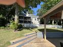Home exterior with a view of a large backyard, deck, and a white picket fence at 929 Sagamore Dr, Louisburg, NC 27549
