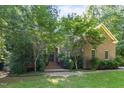 Charming brick home with mature trees, offering a tranquil and private setting at 1003 Gloucester Ct, Chapel Hill, NC 27516