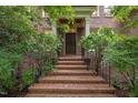 Inviting brick front porch with decorative columns and a dark wooden door at 1003 Gloucester Ct, Chapel Hill, NC 27516