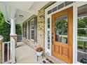 Close-up of the front entrance with a decorative wooden door and brick siding at 1008 Wolfs Bane Dr, Apex, NC 27539