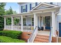 Inviting front porch featuring classic columns and ample seating, perfect for relaxation at 101 Ironcreek Pl, Apex, NC 27539