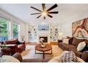 Cozy living room with built-in bookshelves, a fireplace, plush seating, and lots of natural light at 101 Ironcreek Pl, Apex, NC 27539