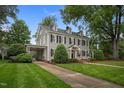 Two-story home with a well-maintained lawn, covered carport, and traditional architectural style at 1015 Watts St, Durham, NC 27701