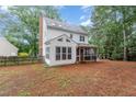 View of the backyard with a screen porch, brick chimney, and partial fence at 105 Houston Cir, Cary, NC 27513