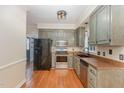 Classic kitchen features painted cabinets, stainless steel appliances, and hardwood floors at 105 Houston Cir, Cary, NC 27513