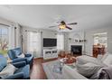 Cozy living room featuring a fireplace, comfortable seating, and a ceiling fan at 105 Stoney Dr, Durham, NC 27703