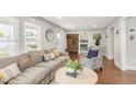 Open-concept living room with a comfortable couch, hardwood floors, and stylish decor at 106 E Delafield Ave, Durham, NC 27704