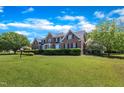 Beautiful brick home with a manicured lawn and lush landscaping at 107 Stargrass Ave, Clayton, NC 27527
