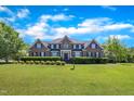 Beautiful brick home with a manicured lawn and lush landscaping at 107 Stargrass Ave, Clayton, NC 27527