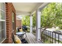 Cozy outdoor balcony with a table and chairs, perfect for enjoying a neighborhood view at 109 Longchamp Ln, Cary, NC 27519