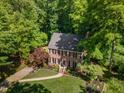 Aerial view of a brick home surrounded by mature trees at 1104 Berwyn Way, Raleigh, NC 27615