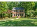 Classic brick home with lush green lawn and mature trees at 1104 Berwyn Way, Raleigh, NC 27615