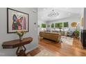 Sun-filled living room featuring hardwood floors, vaulted ceilings, and stylish furnishings with large windows at 1115 Trailwood Dr, Raleigh, NC 27606