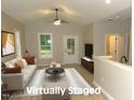 Bright, staged living room featuring a white sofa, neutral tones, and ample natural light from the window at 119 Oak Ridge Rd, Franklinton, NC 27525