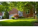 Attractive brick home featuring a well-manicured lawn and mature trees, offering great curb appeal at 123 Chimney Rise Dr, Cary, NC 27511