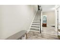 Bright entryway features staircase and gray floors, leading to a partially visible room at 127 Manordale Dr, Chapel Hill, NC 27517