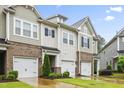 Attractive townhomes feature brick accents, attached garages, and manicured landscaping at 127 Manordale Dr, Chapel Hill, NC 27517