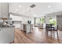 Open-concept living space showcasing the kitchen, dining area, and living room with hardwood floors and natural light at 1310 Compass Dr, Durham, NC 27713