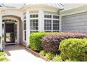 Close up on the front of house showing bay window and neatly manicured landscaping around the entrance at 1405 Ventnor Pl, Cary, NC 27519
