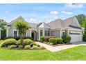 Charming single-story home featuring a well-manicured lawn, tidy landscaping, and an attached two-car garage at 1405 Ventnor Pl, Cary, NC 27519