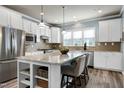 Bright kitchen with a spacious granite island, stainless steel appliances, and modern white cabinetry at 1520 Palmer Hill Dr, Durham, NC 27703