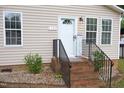 The front entry features brick steps with metal railings and a white front door surrounded by symmetrical windows at 1536 Granville Street, Burlington, NC 27215