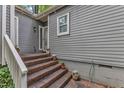 Welcoming entrance featuring brick steps, elegant plants, and gray siding at 1702 Falls Church Rd, Raleigh, NC 27609