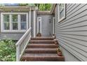 Close-up of home's entrance with charming brick steps and potted plants at 1702 Falls Church Rd, Raleigh, NC 27609