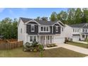 Charming two-story home with landscaped yard, black shutters, and attached two-car garage at 188 Karlov Rd, Garner, NC 27529