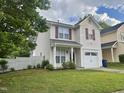 Charming two-story home featuring a one-car garage, landscaped yard, and inviting front porch at 1924 Barngate Way, Raleigh, NC 27614