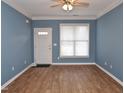 The living room has a front door, window and hardwood floors at 1924 Barngate Way, Raleigh, NC 27614