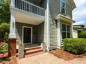 Inviting entrance with red brick steps leading to a black front door and a small balcony at 201 Cooke St, Raleigh, NC 27601