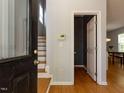 Entrance featuring hardwood floors, stairs to the left, and a doorway to another room at 201 Cooke St, Raleigh, NC 27601