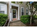 Inviting front entrance with stylish wreath, green bushes, and well-kept walkway at 214 Cedar Elm Rd, Durham, NC 27713