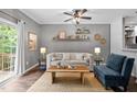 Beautifully decorated living room with natural light, rustic wood accents and open floor plan at 214 Cedar Elm Rd, Durham, NC 27713