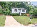 Well-maintained two-story home with light blue siding, a long driveway, and a green lawn at 2216 Lawrence Dr, Raleigh, NC 27603