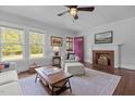 Cozy living room featuring a fireplace, hardwood floors, and ample natural light at 2227 Us-15, Creedmoor, NC 27522
