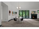 The dining room features a fireplace, art, and access to the outdoors at 224 Crawford Rd, Hillsborough, NC 27278
