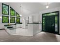Bright kitchen with updated appliances, green trim, and views of the outdoors at 224 Crawford Rd, Hillsborough, NC 27278