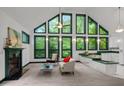 Bright open living space featuring a fireplace and large windows with picturesque views at 224 Crawford Rd, Hillsborough, NC 27278