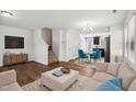 Bright living room featuring hardwood floors, a staircase, and an open layout perfect for entertaining at 246 Spark St, Raleigh, NC 27606