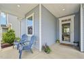 Inviting front porch features blue chairs and a clear view to the home's entry door at 256 Summer Ranch Dr, Fuquay Varina, NC 27526