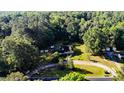 A captivating aerial view showcasing the property nestled amidst lush greenery, offering privacy and tranquility at 2619 Steel Bridge Rd, Sanford, NC 27330