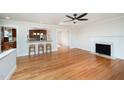 Open-concept living room featuring hardwood floors, fireplace, and a bar area at 2800 Glen Burnie Dr, Raleigh, NC 27607