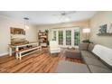 Open floor plan featuring a dining area, sliding glass doors, luxury vinyl plank flooring, and a gray sofa at 2822 Pickett Rd # 173, Durham, NC 27705