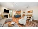 Open floor plan featuring a modern kitchen, dining area, fireplace, and luxury vinyl plank flooring at 2822 Pickett Rd # 173, Durham, NC 27705