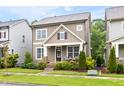 Charming two-story home with stone accents, inviting front porch, and well-maintained landscaping at 306 Crossland Dr, Chapel Hill, NC 27517