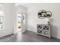 Bright foyer with stylish decor, wood floors, and an open view to the front door and porch at 306 Crossland Dr, Chapel Hill, NC 27517